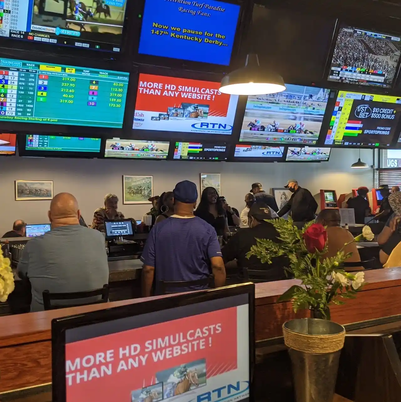 Black Eyed Susan Lansing location with sports betting screens and customers watching racing
